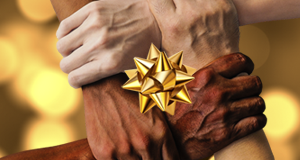 image of four hands clasped in the shape of a box